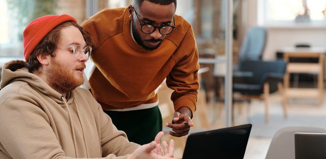 Two-men-looking-at-laptop-screen