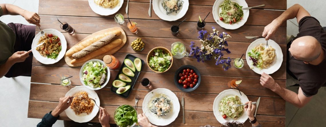 A group of people sit down for a meal